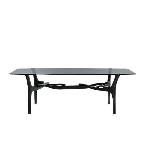 BD Carlina Low Table with a smoked glass top and sleek rectangular profile. Its sculptural wooden base features fluid, intersecting supports, creating a distinctive architectural character.