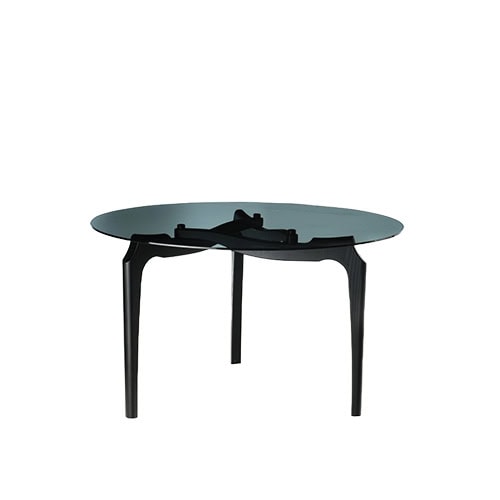 BD Carlina Round Dining Table features a smoked glass top on a sculpted black wood base with refined, architectural legs. Its clean, minimal design is set against a white backdrop, highlighting its sleek silhouette.