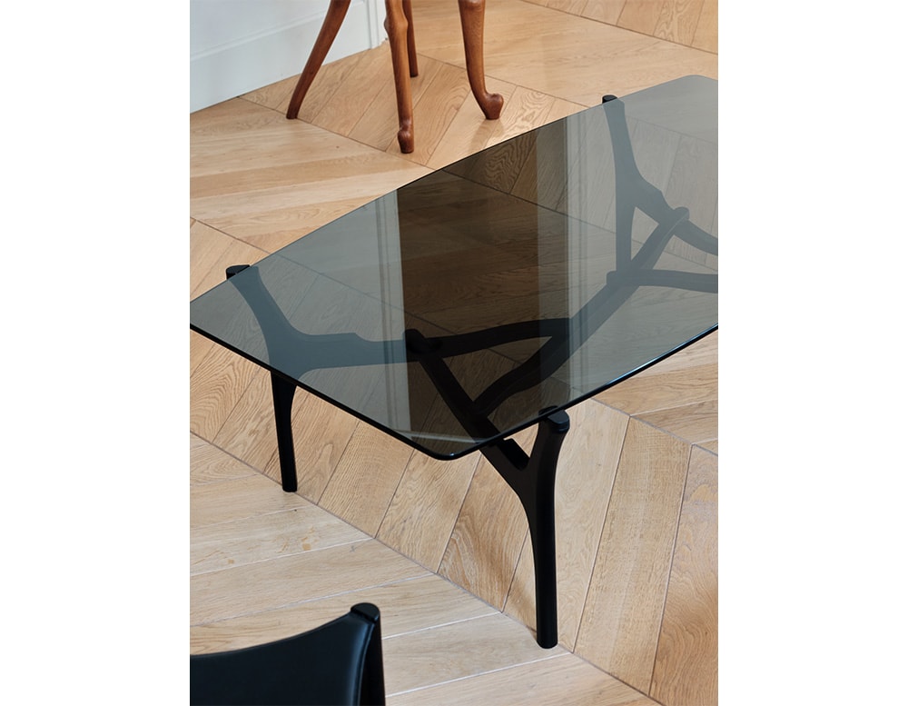 table with black or transparent glass top and thin black wooden base