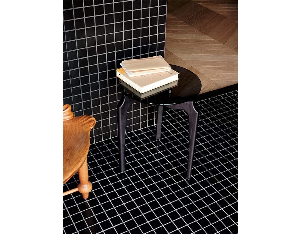 table made of black wood with circular top made of black or transparent glass