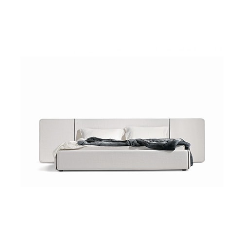 bed made of wood and upholstered in white leather with a zipper on the sides giving it volume and style