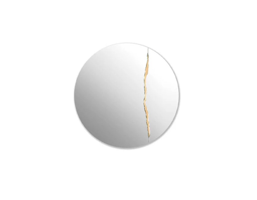 circular mirror made of clear glass with a gold brass finish decoration on a white background