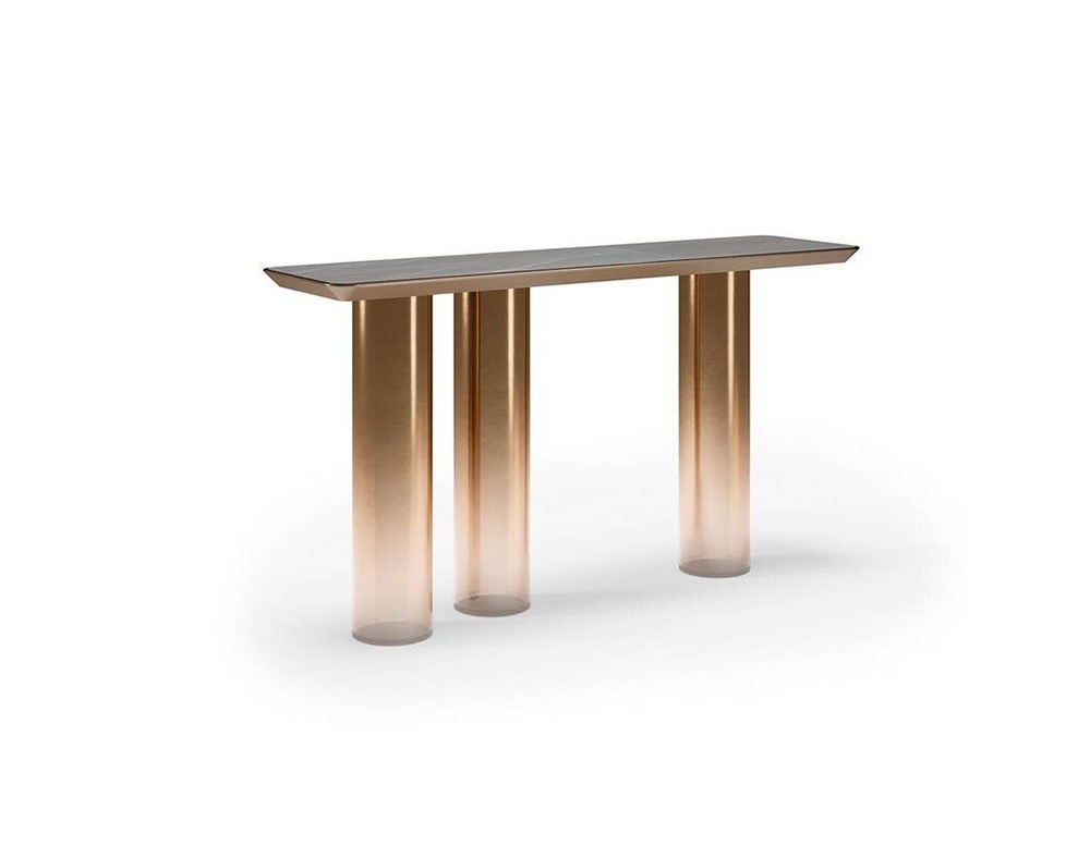 table made of brass with 3 axes of faded rosa color and shiny brass top on a white background