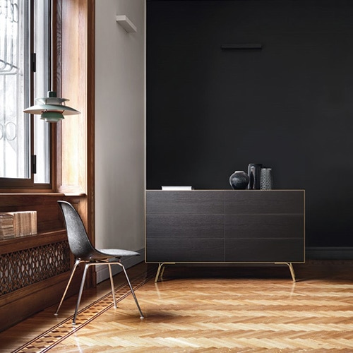 veneered table made of black wood and metal base in a room