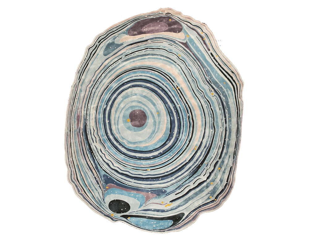 rug made of fabric with a design thought of the agata stone with the same very exclusive color palette in a white background