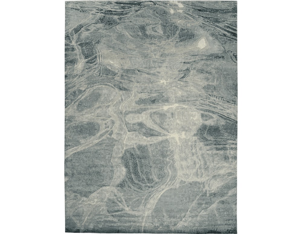 rug made of fabric with finishes simulating sea waves in a bluish tone in different intensities