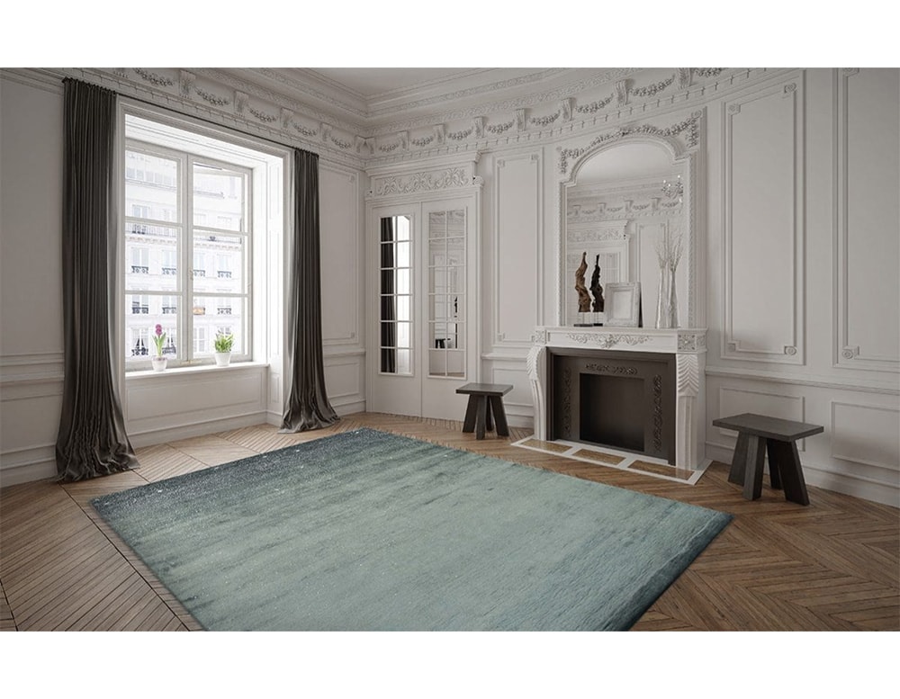 handmade carpet coin wool and fabric finished with drops simulating falling in a blue tone in a living room