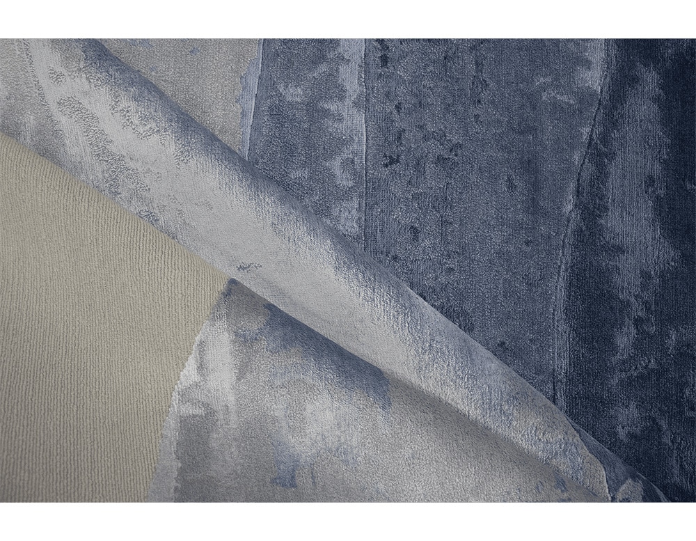 rug made of wool and hand-knotted in a shade of blue with white