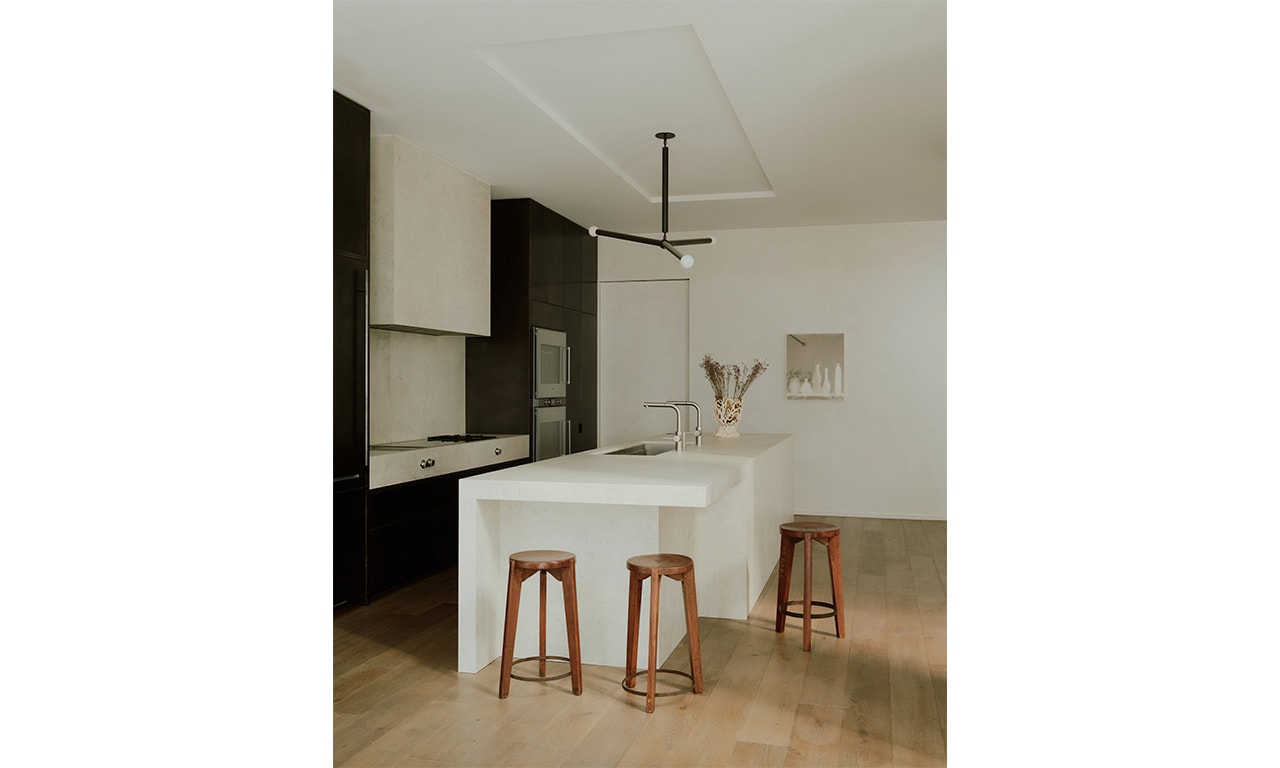 A modern kitchen with a sleek monochrome palette, warm wooden accents, and a minimalist design, creating a balance of sophistication and comfort