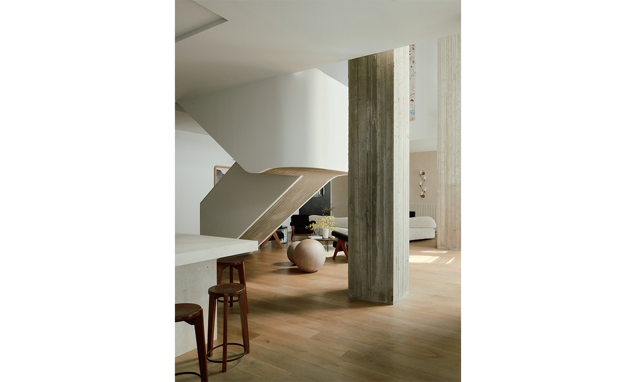 A modern interior with striking architectural elements, textured materials, and a warm, earthy color palette that creates a sense of elegance and comfort