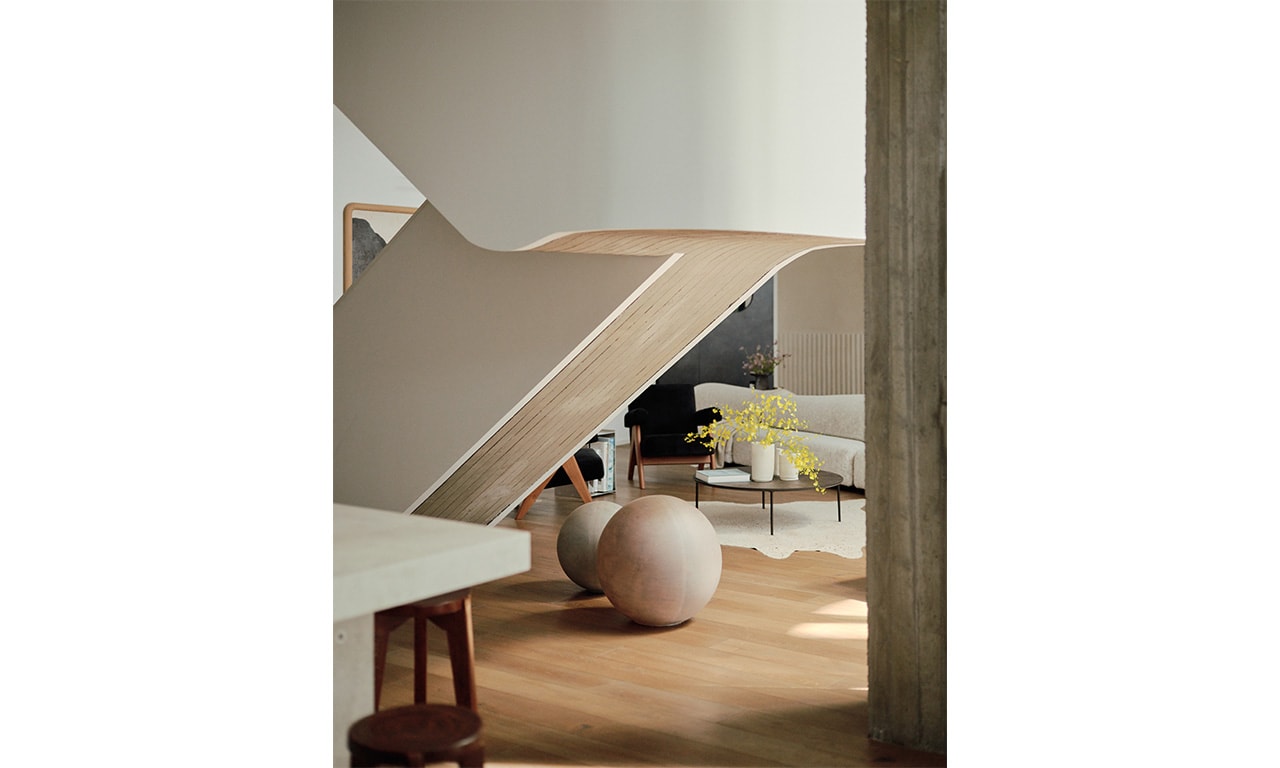 A beautifully designed interior featuring sculptural architecture, warm wood flooring, and soft, neutral tones for a harmonious and inviting atmosphere