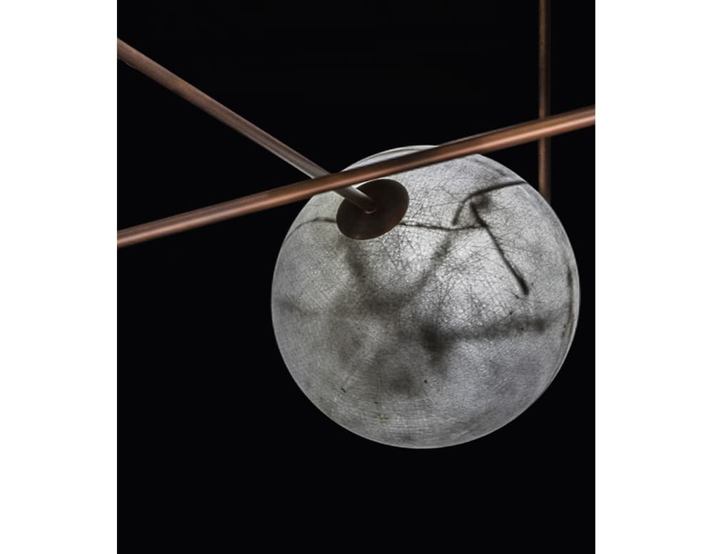 sphere shaped lamps made of fiberglass and with brass and metal stems in white and gold tones
