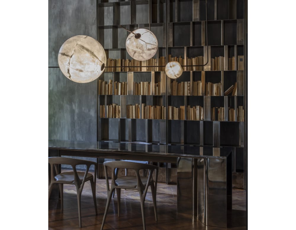 sphere shaped lamps made of fiberglass, brass and gold metal in a room.