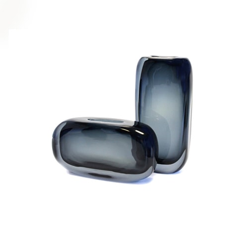 small glass sculptures with a gradient blue tone on a white background.