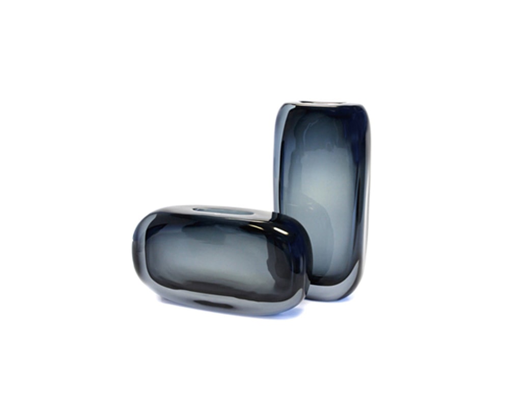 small glass sculptures with a gradient blue tone on a white background.