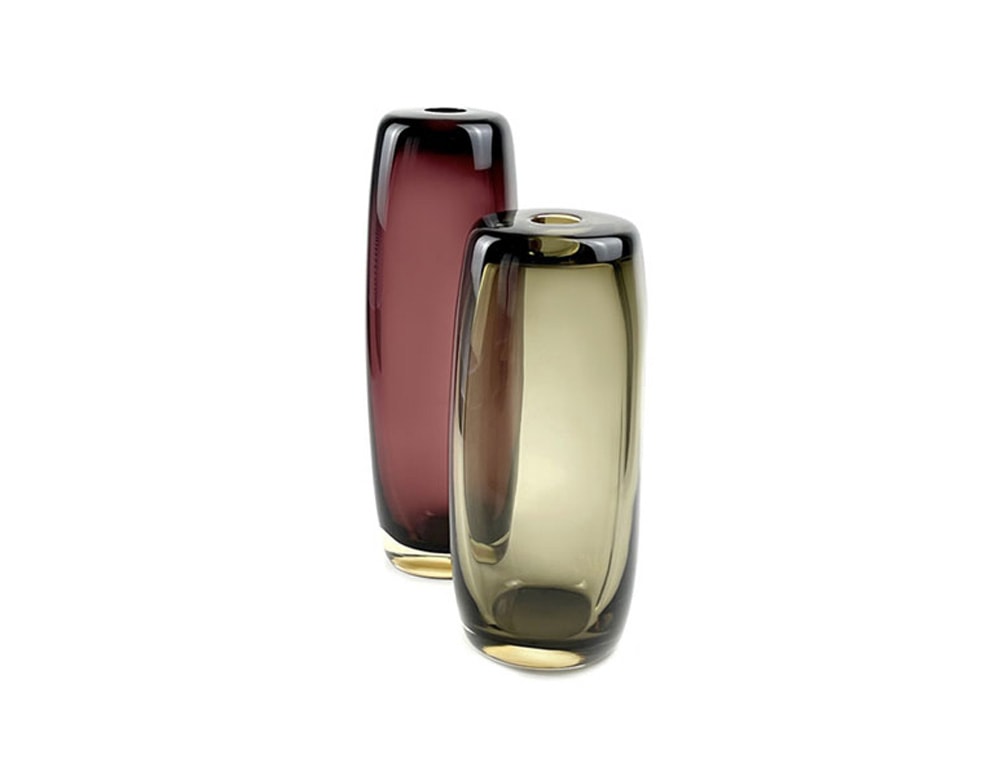 long cylindrical glass sculptures with a shade of yellow and pink colors.