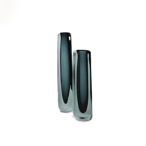 glass sculptures with a long square shape and a small bird on top in a dark blue tone