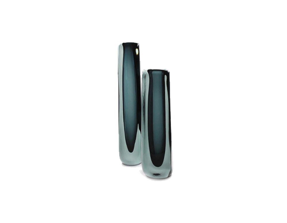 glass sculptures with a long square shape and a small bird on top in a dark blue tone in a white background