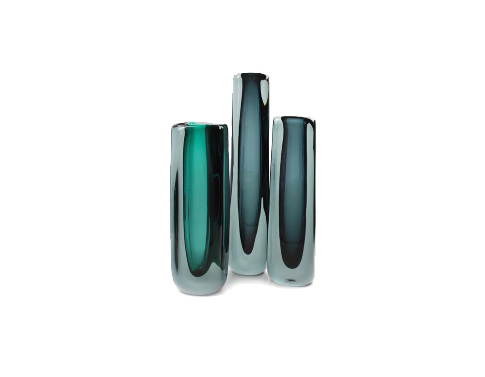 small glass sculptures of different sizes varying in blue tones with a small opening at the top.