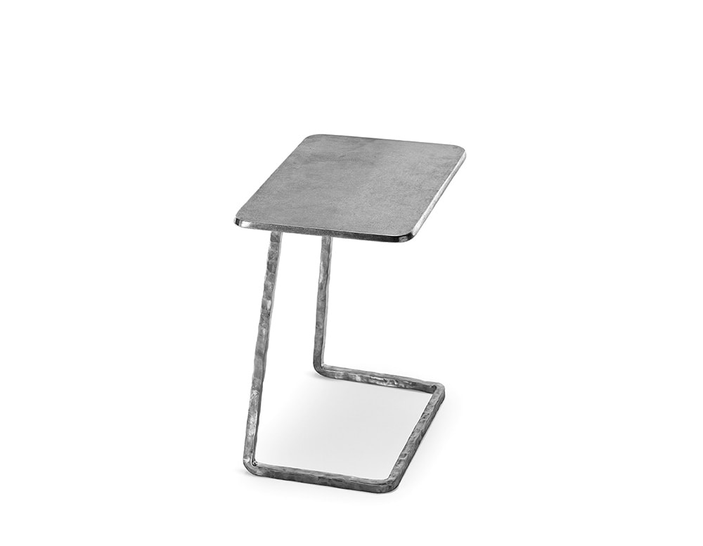 coffee table made of bronze painted in shades of silver and on a white background