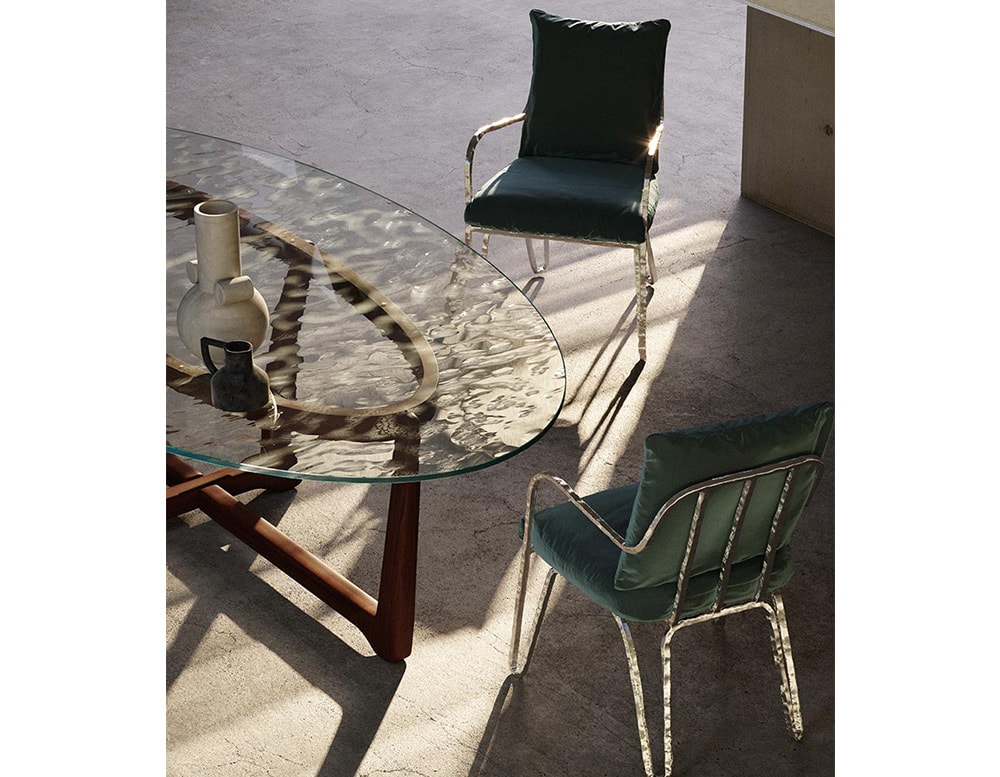 outdoor chair made with a base made of gold aluminum and upholstered in blue fabric.