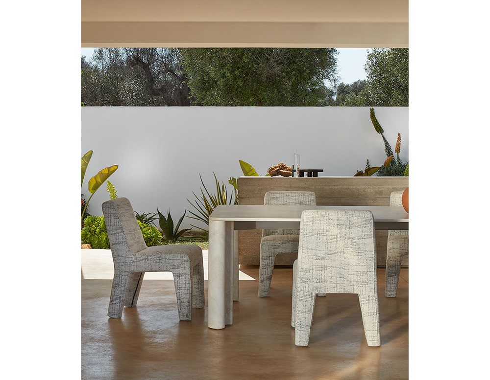 chairs made with an aluminum base and upholstered with girs fabric in a living room.