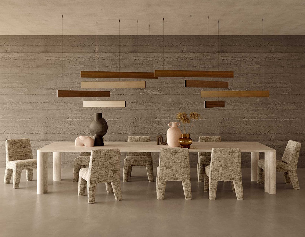 dining room chairs made with an aluminum base and upholstered with gray fabric.