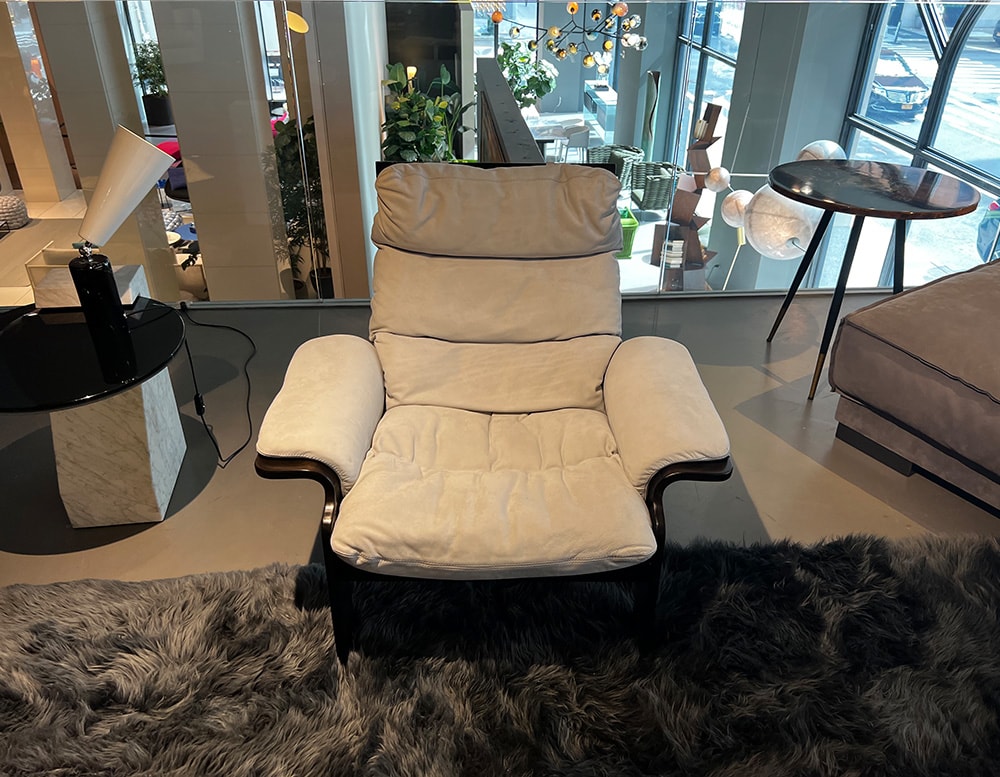 Dark brown wooden armchair with an iced gray suede finish