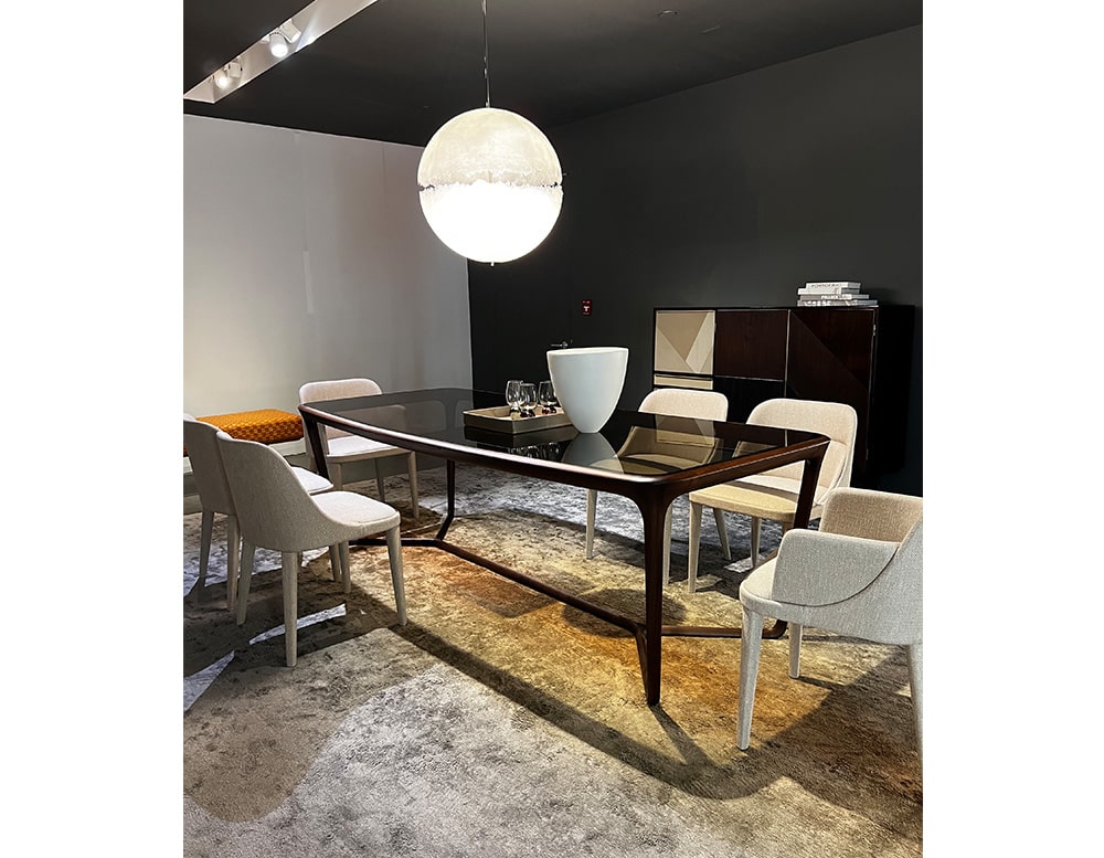 Dining table with a central cross-shaped wooden base sash, ties together the parts and supports the top made in glass color bronzed
