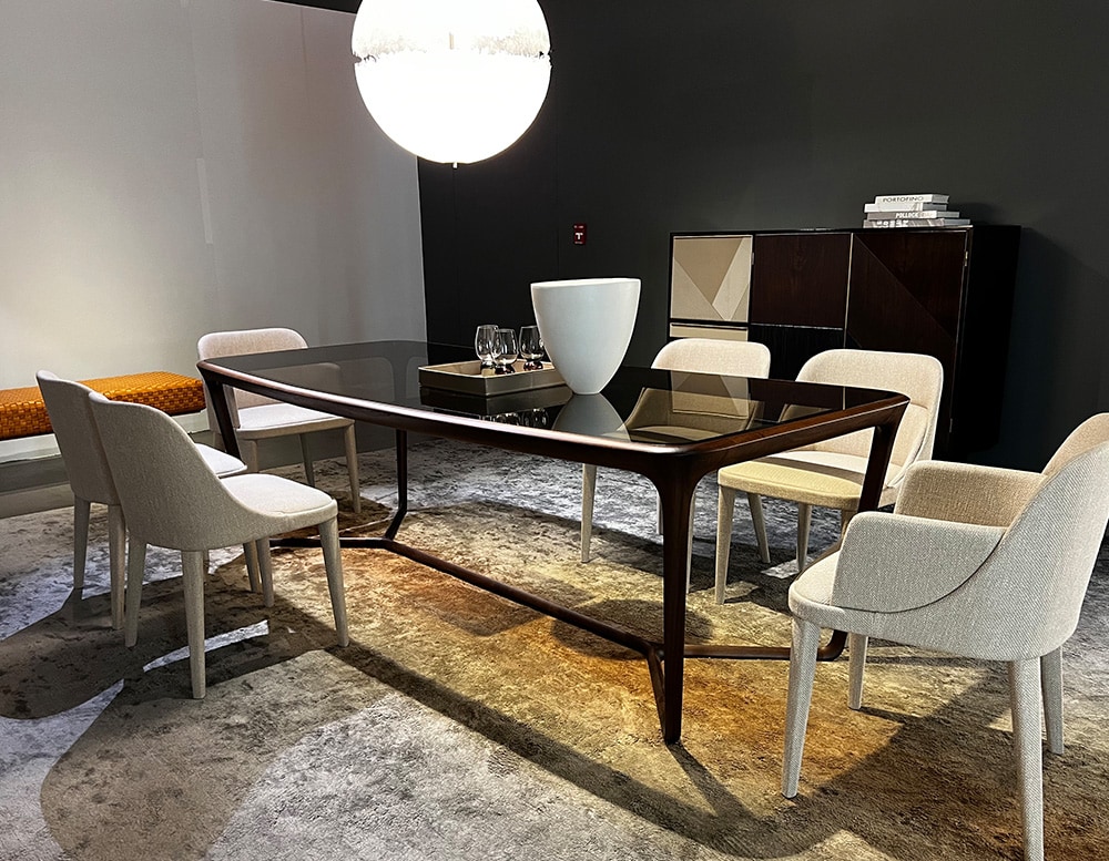 Dining table with a central cross-shaped wooden base sash, ties together the parts and supports the top made in glass color bronzed