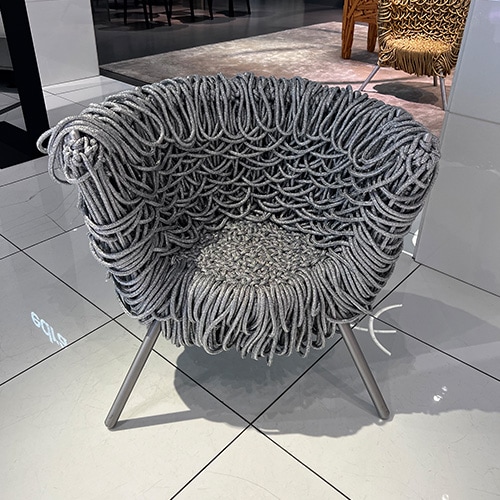 armchair created from acrylic, aluminum and steel bases with shades of colors such as silver and gold.