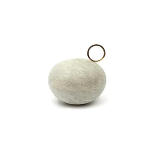 small soapstone vessels with different shades of white and brass finishes, used to store small precious objects in a white background.