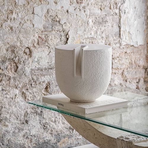 sculpture based on ceramic with a particular narrow opening in the white upper part.