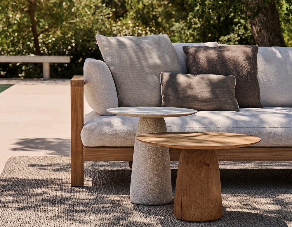 auxiliary tables with circular top made of solid stone or light brown wood in a living room