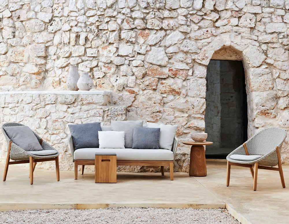 auxiliary table made of light brown wood with circle-shaped top in a living room