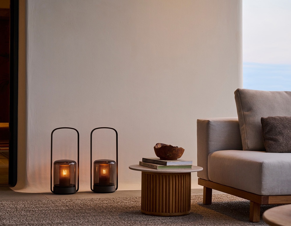 portable lamps made of black glass and black aluminum of the same size in a room