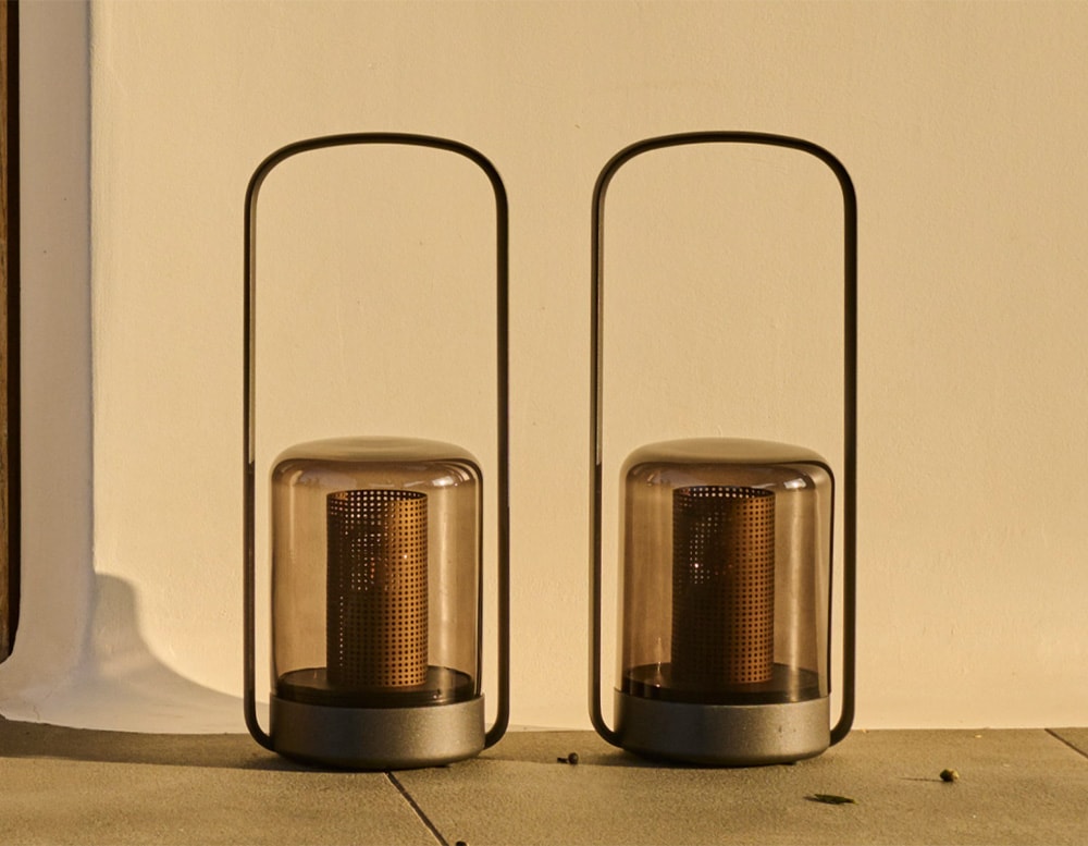 portable lamps made of black glass and black aluminum of the same size in an outside