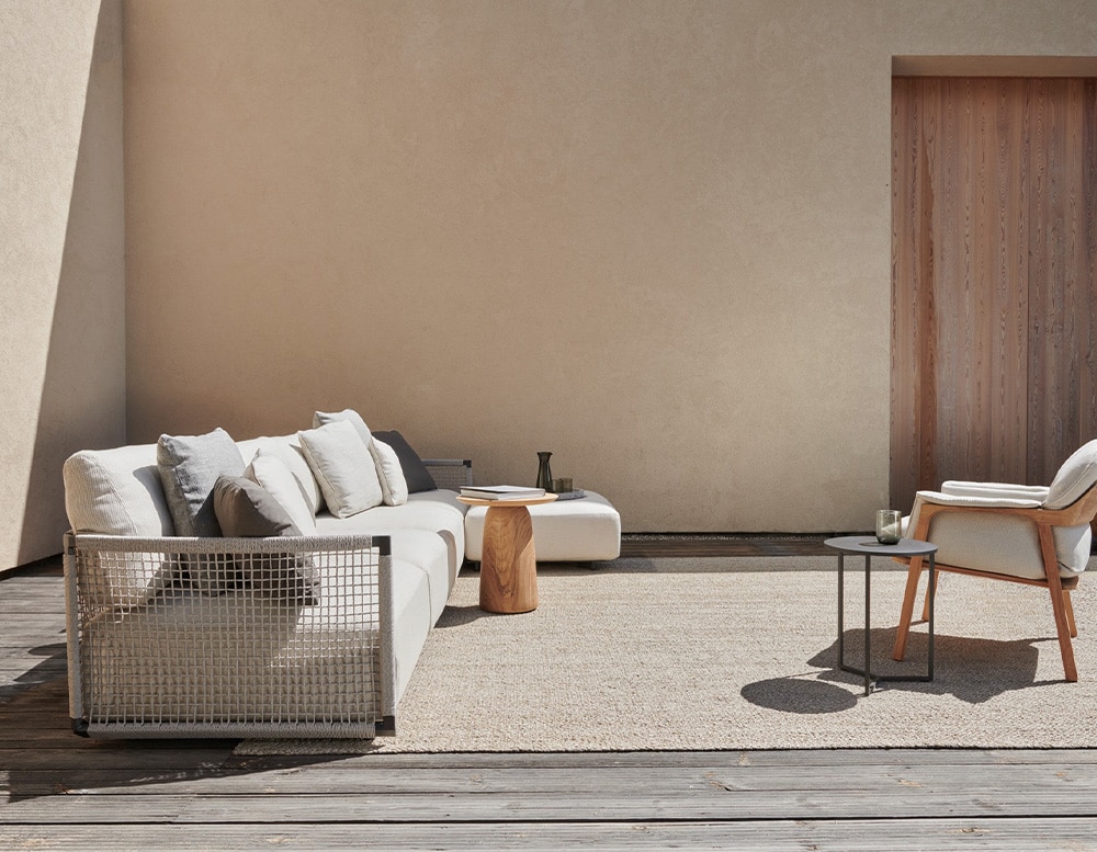 sofa made with a stainless steel base and upholstered in gray fabric on the outside