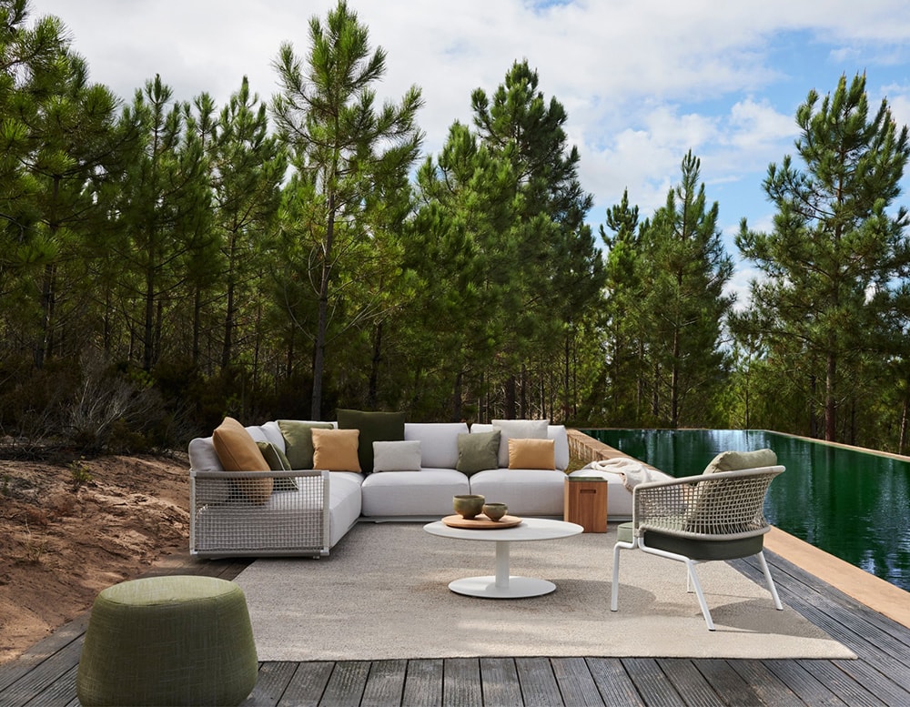 sofa made with stainless steel base and upholstered in gray fabric in the outside