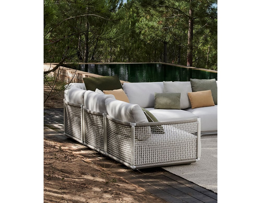 sofa made with stainless steel base and upholstered in gray fabric