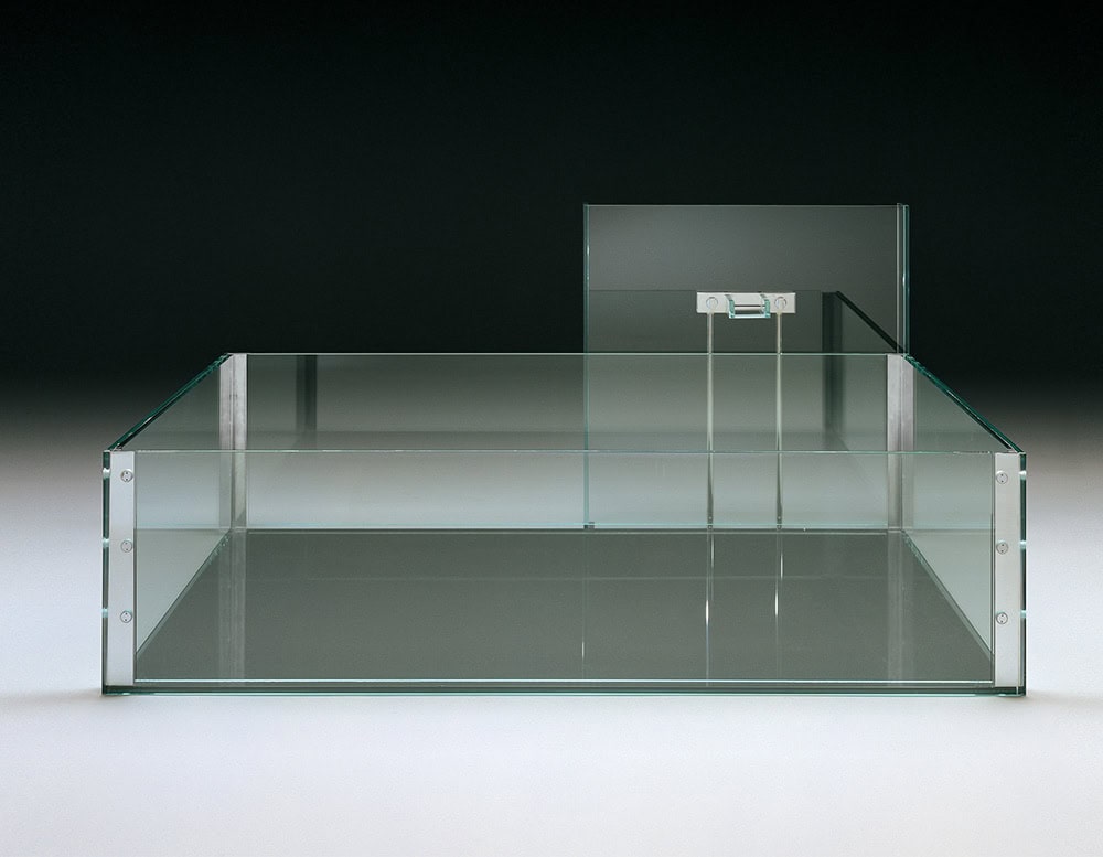 A sleek, modern glass bathtub with transparent walls, featuring a minimalist faucet fixture against a dark, elegant backdrop