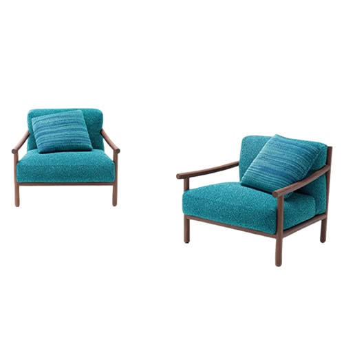 Elegant armchairs with teal upholstery and matching cushions paired with sleek wooden frames for a fresh and modern seating style.