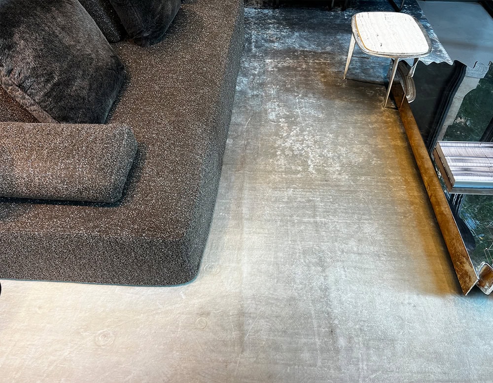 A luxurious custom Bambu Silk Rug featuring a soft gradient design in neutral tones complementing a modern seating area with plush furnishings