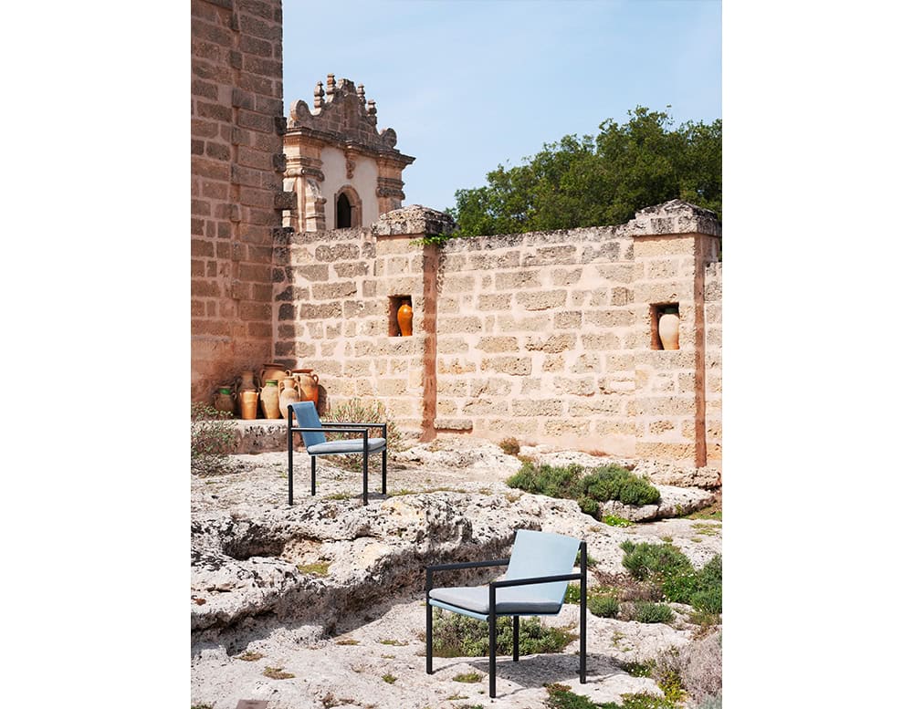 Elegant outdoor chairs with slim black frames and soft-toned upholstery, perfectly suited for serene garden or patio settings.