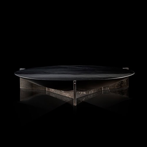 Sculptural and bold, the Muse Coffee Table features a round black stone top and intersecting textured metal base. Its minimalist silhouette contrasts beautifully with its striking materials, creating a strong statement piece for modern interiors.