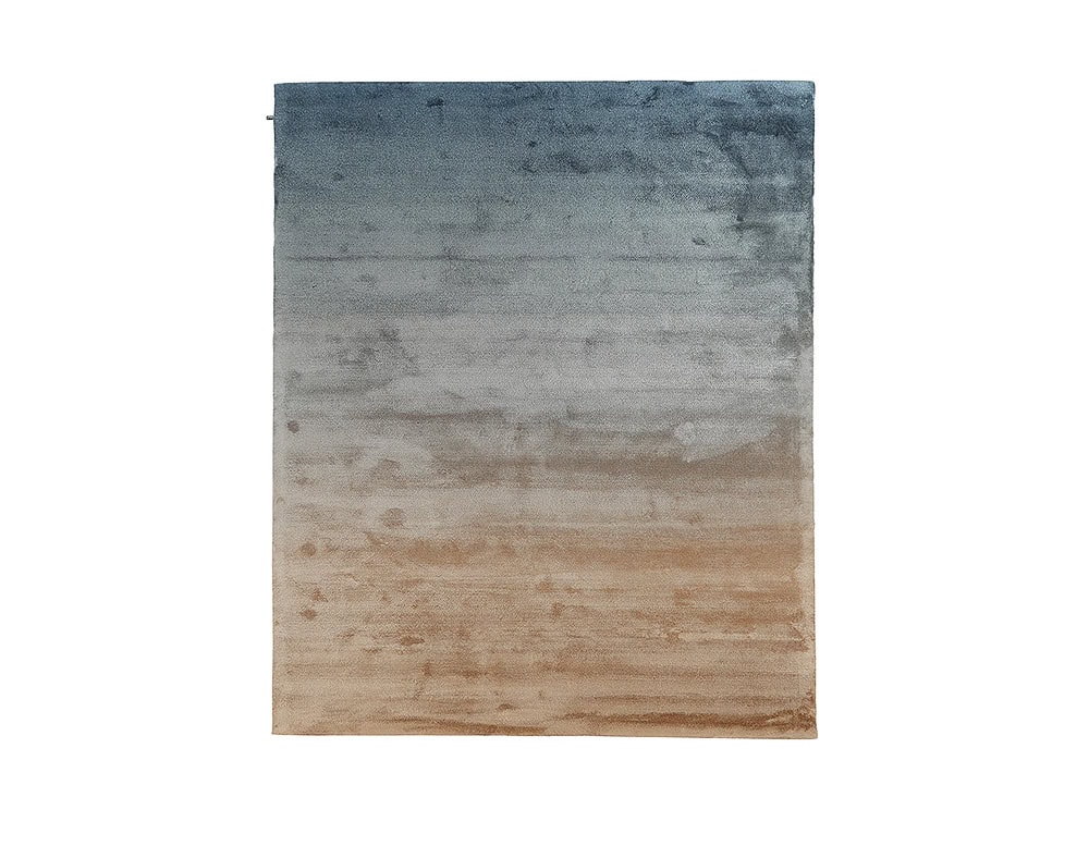 DeViant Rug flows from deep ocean blue through cool gray and fades into warm sandy beige, offering a serene gradient that brings depth and natural balance to modern interiors.