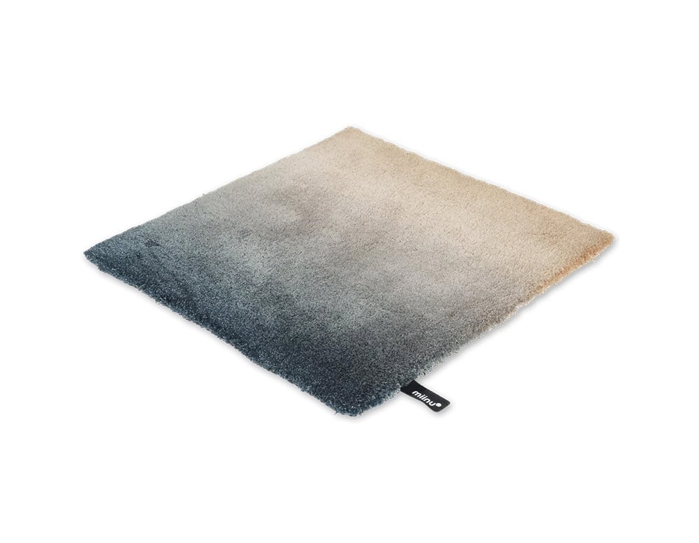 DeViant Rug pairs soft beige with deep blue, offering a gentle transition of tones that evokes sand meeting sea, ideal for serene and balanced environments.