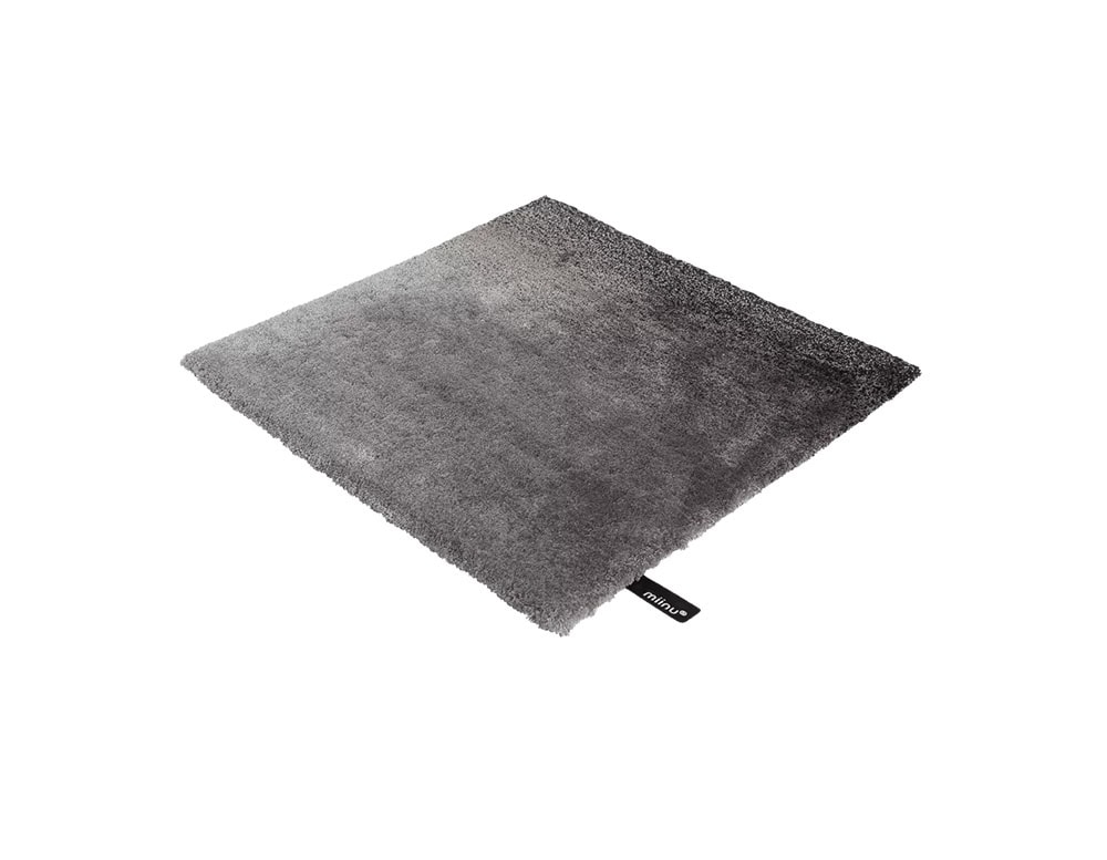 DeViant Rug features a bold gradient in varying shades of gray, transitioning from soft silver to deep charcoal, creating a sleek, modern look. Its plush surface offers tactile comfort, ideal for grounding monochrome or industrial-inspired interiors.