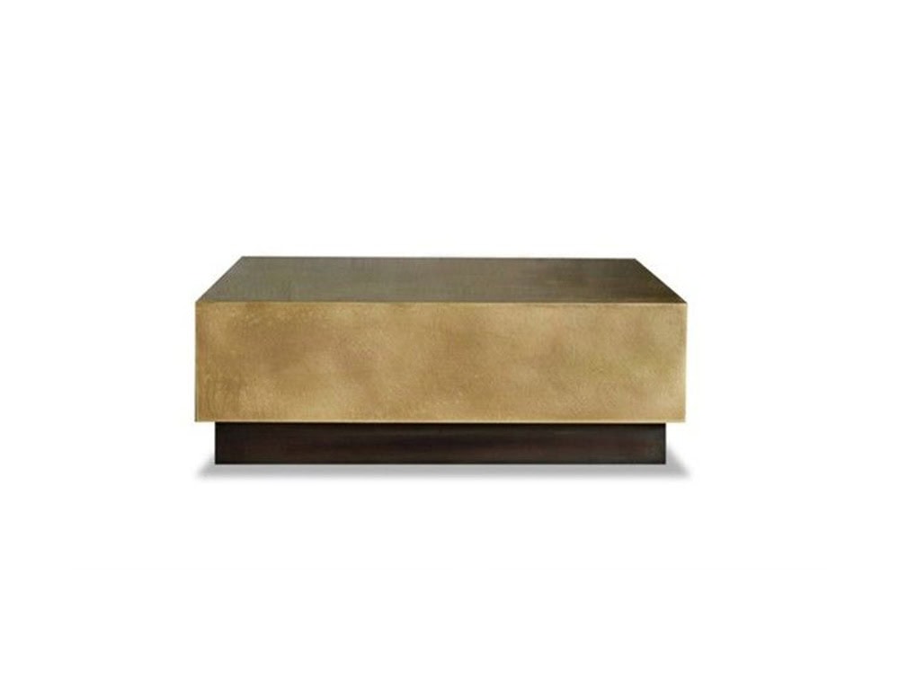 Bax Loren Coffee Table in a bold cuboid form with a rich brass finish and contrasting dark recessed base. Its minimalist geometry and luxe surface make it ideal for sophisticated modern interiors.