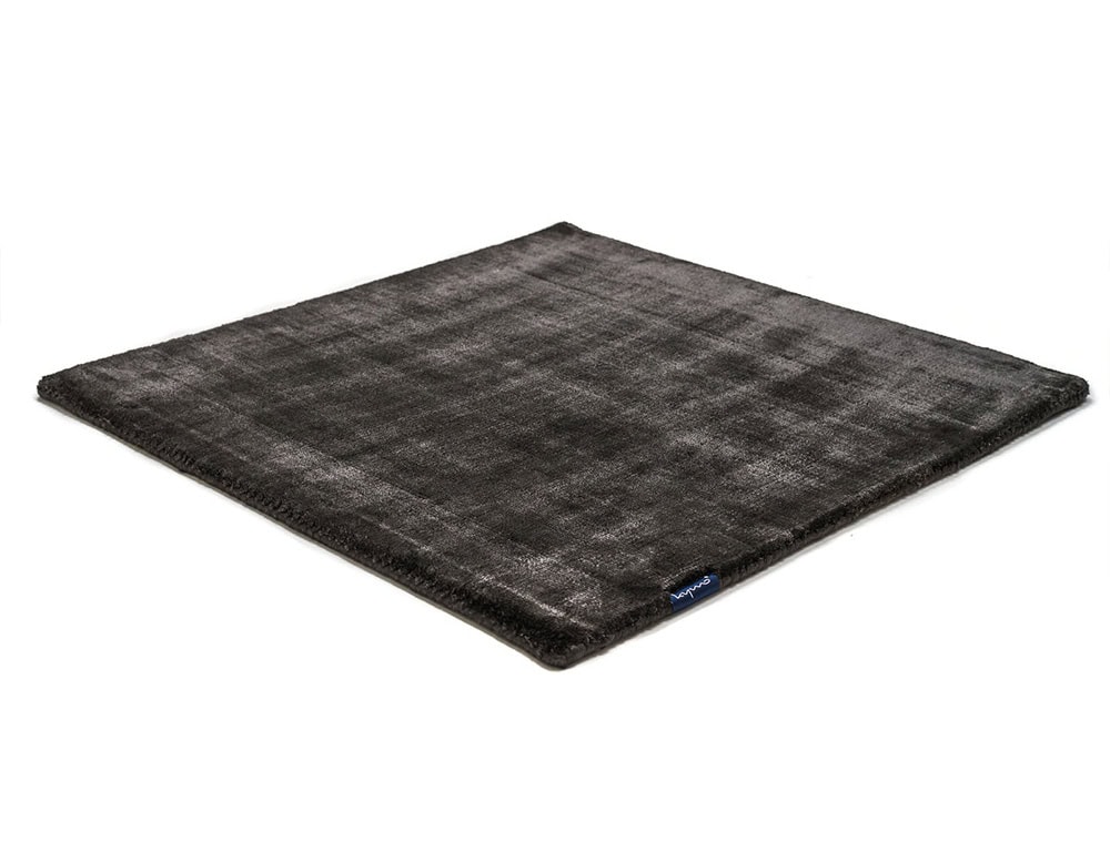 Pearl Rug in Panther showcases a luxurious velvet-like sheen and rich dark tone, making it a striking foundation for contemporary interiors. Its plush surface and dense weave add warmth, texture, and depth to any setting with understated elegance.